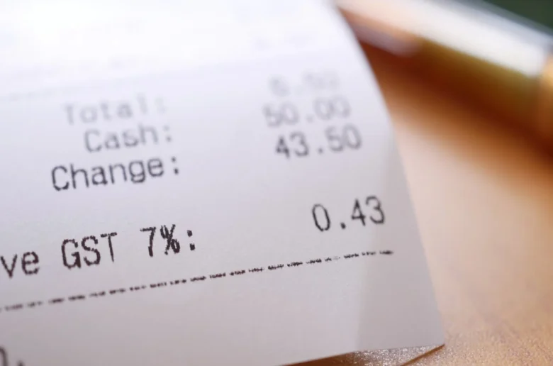 Receipt showing totals: cash paid 50.00, change 43.50, GST 7% (0.43) and total amount on the left side